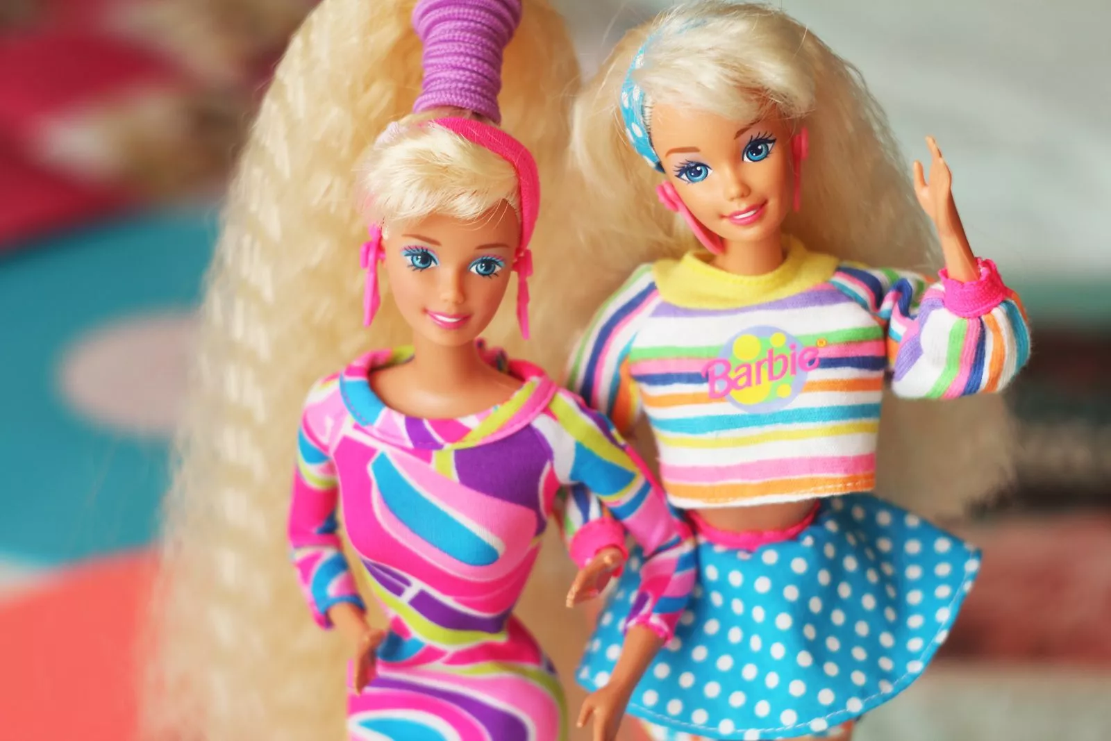 Two Barbie dolls stand side-by-side