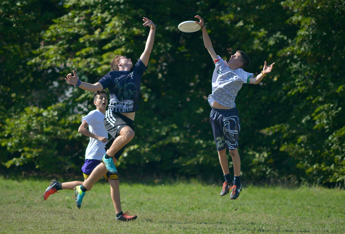 Young boys playing Ultimate frisbee
